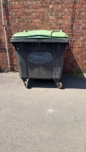 Secondhand 1100L Plastic Wheelie Bin in Black with Green Lid