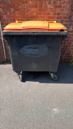 Secondhand 660L Plastic Wheelie Bin in Black with Orange Lid