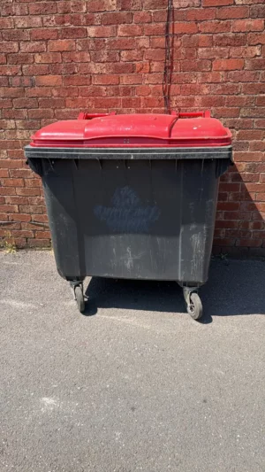 Secondhand 1100L Plastic Wheelie Bin in Black with Red Lid