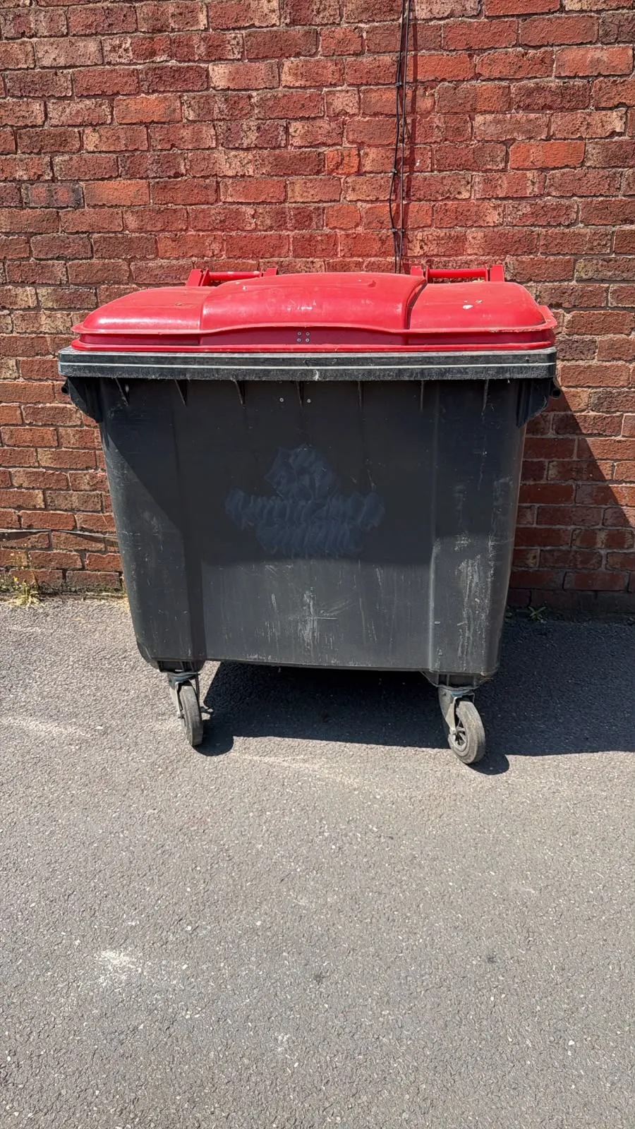 Secondhand 1100L Plastic Wheelie Bin in Black with Red Lid
