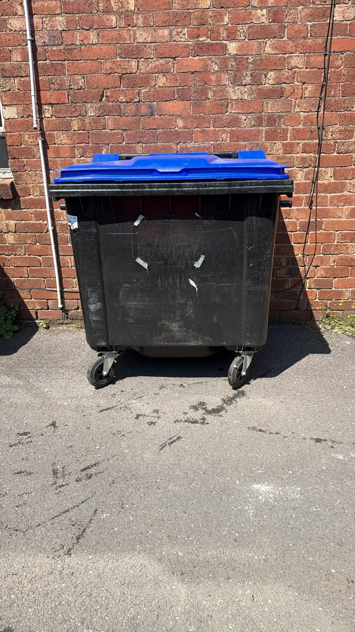 Secondhand 1100L Plastic Wheelie Bin in Black with Blue Lid