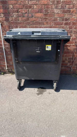 Secondhand 660L Plastic Wheelie Bin in Black with Drop Front